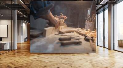 Handmade concept. Women's hands do the product of wood. Wood workshop with a tool and a lamp Wall mural