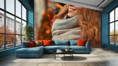 Happy young woman with a magic smile in fashion stylish knitwear clothes with a knitted gray hat and scarf near the lights on a holidays Wall mural