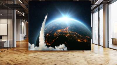 Space Rocket lift off. Space shuttle with smoke and blast takes off into space on a background of blue planet earth with amazing sunset. Successful start of a space mission. Travel to Earth. Wall mural