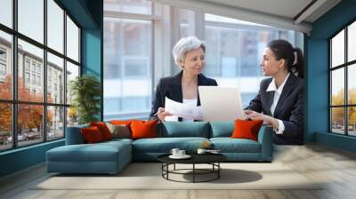 Two women working with laptop Wall mural