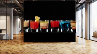 Mix alcoholic cocktail shots together with isolated black background Wall mural