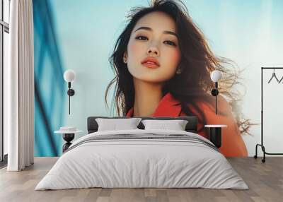 Beautiful Asian woman wearing stylish clothes while posing gracefully looking at the camera Wall mural