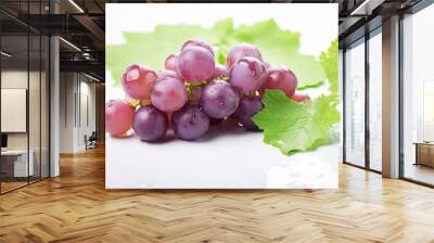 Fresh red grapes with green leaves isolated on white background. Wall mural