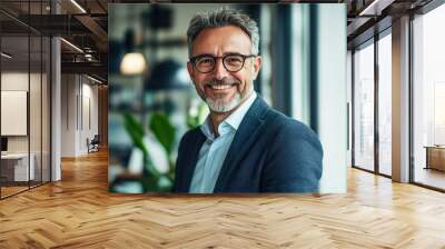 Middle aged professional business man with glasses wearing white shirt and suit happily smiling standing in office near glass window Wall mural