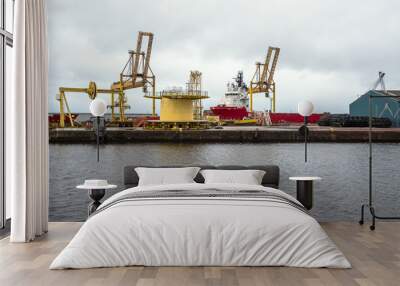 Deep water port with quayside shipping cranes and a moored freight ship on a cloudy summer day. Leith, Edinburgh, Scotland Wall mural