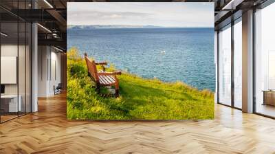 Empty Wooden Bench Facing the Sea at Sunset Wall mural