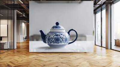 A retro white porcelain teapot with blue traditional handmade motifs on white kitchen counter - Generative AI Wall mural