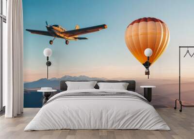 A small plane flying alongside a large hot air balloon Wall mural