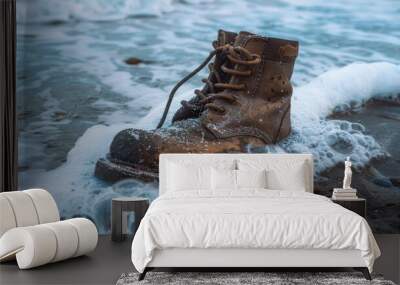 Old boot submerged in beach sand, fierce ocean waves in the background, raw style Wall mural