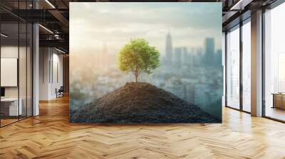 A small tree is growing on a city background Wall mural