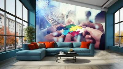 Business people join puzzle pieces in office. Concept of teamwork and partnership. double exposure with light effects Wall mural