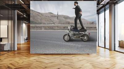 Businessman does dangerous stunts Wall mural