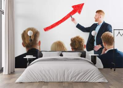 Businessman draws positive statistics of his company during a training meeting. Concept of success Wall mural