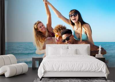 Cheerful young friends enjoying summertime on the beach Wall mural