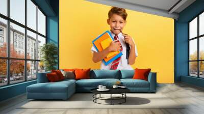 Child cries because he has a lot of school homework. Emotional expression. Yellow background Wall mural