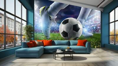 Football scene at night match with close up of a soccer shoe hitting the ball with power. Wall mural