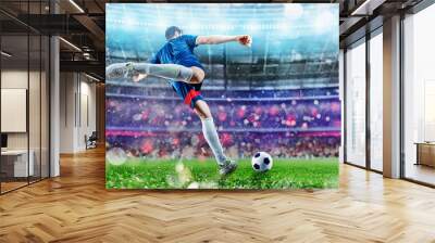 Football scene at night match with player kicking the ball with power. Wall mural