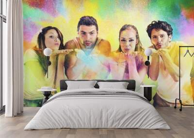 Friends blowing colored powders Wall mural