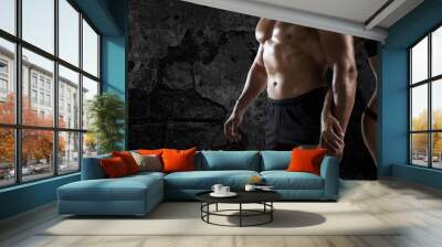 Muscled man and woman at the gym Wall mural