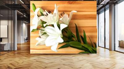 Beautiful white lilies on a wooden table. View from above Wall mural