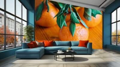 Tangerines with leaves on rustic wooden background Wall mural