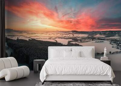 Aerial view of a dramatic pink sunset over the snowy landscape - great for a wallpaper Wall mural