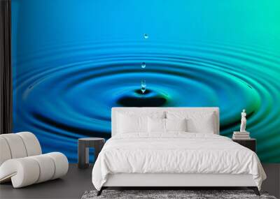 water drop close up with concentric ripples colourful blue and g Wall mural