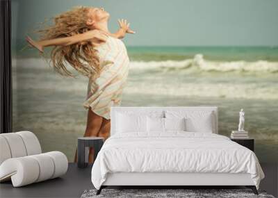 flying jump beach girl on blue sea shore in summer vacation Wall mural