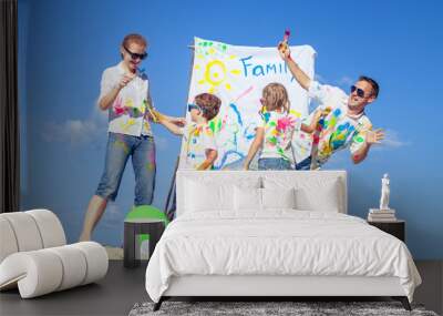 Happy family playing on the beach at the day time. Wall mural