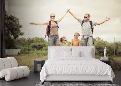 Happy family walking on the railway at the day time. Wall mural