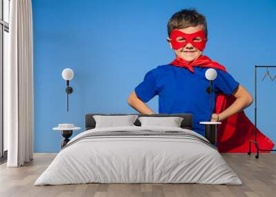 Happy little child playing superhero. Wall mural