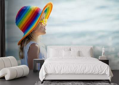 happy little girl in the hat  standing at the beach in the day t Wall mural