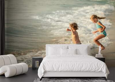 Two happy children  playing on the beach Wall mural