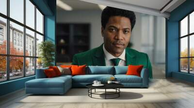 adult black hair american man in green formal attire model portrait looking confident on an office background for ad concept space for text Wall mural