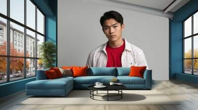 teen stunning brunette asian man with red shirt model portrait standing straight on a plain white background for ad concept space for text Wall mural