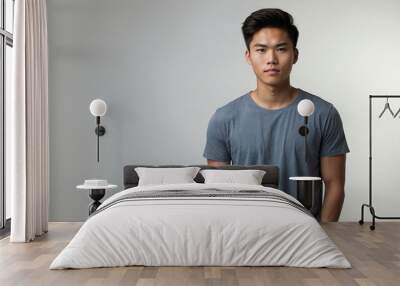 teen stunning brunette east asian man with gray shirt model portrait standing straight on a plain white background for ad concept space for text Wall mural