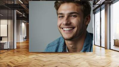 teenage caucasian man on pastel gray background model close-up smiling with beautiful teeth for ad concept space for text Wall mural