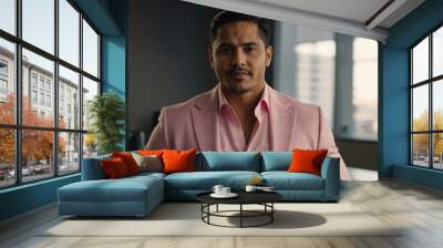 twenties hispanic man in pink attire on office background model portrait looking confident for ad concept space for text Wall mural