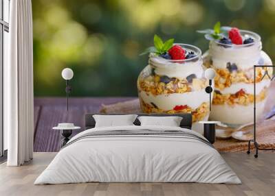 granola with greek yogurt and berries in two glass jars Wall mural