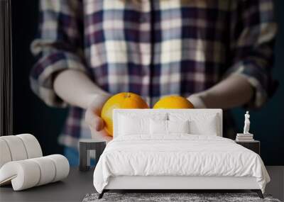 cropped shot of a woman holding two oranges Wall mural