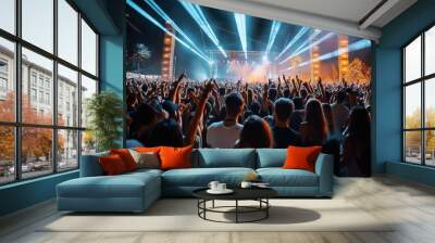 Large crowd at an outdoor music concert with stage lights and performers at night. Wall mural