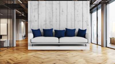 Modern minimalist interior design with a light gray sofa and five dark blue pillows in front of a white wooden plank wall. Wall mural