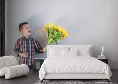 The boy holding flowers. Wall mural