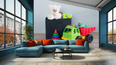 Box with different toys on floor Wall mural