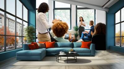 Asian woman talking during a relaxed meeting on a coworking Wall mural