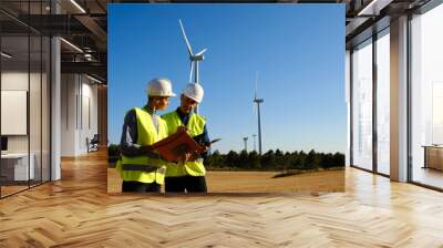 Two engineers working together in a wind turbine field. Wall mural