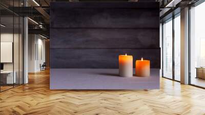 Two thick candles front view with rustic wood background Wall mural