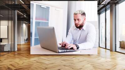 Young IT Engineer Working On Laptop Wall mural