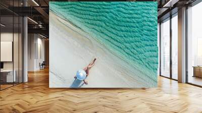 Holidays in the Maldives. Paradise tropical beach. Woman on the background of the sea and sunny beach. Travel, tourism and relaxation Wall mural