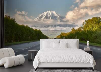 Kamchatka road. Volcanoes of Kamchatka against the backdrop of a beautiful sky and clouds. Kamchatka Peninsula, Russia. Travel and tourism in the natural park Wall mural